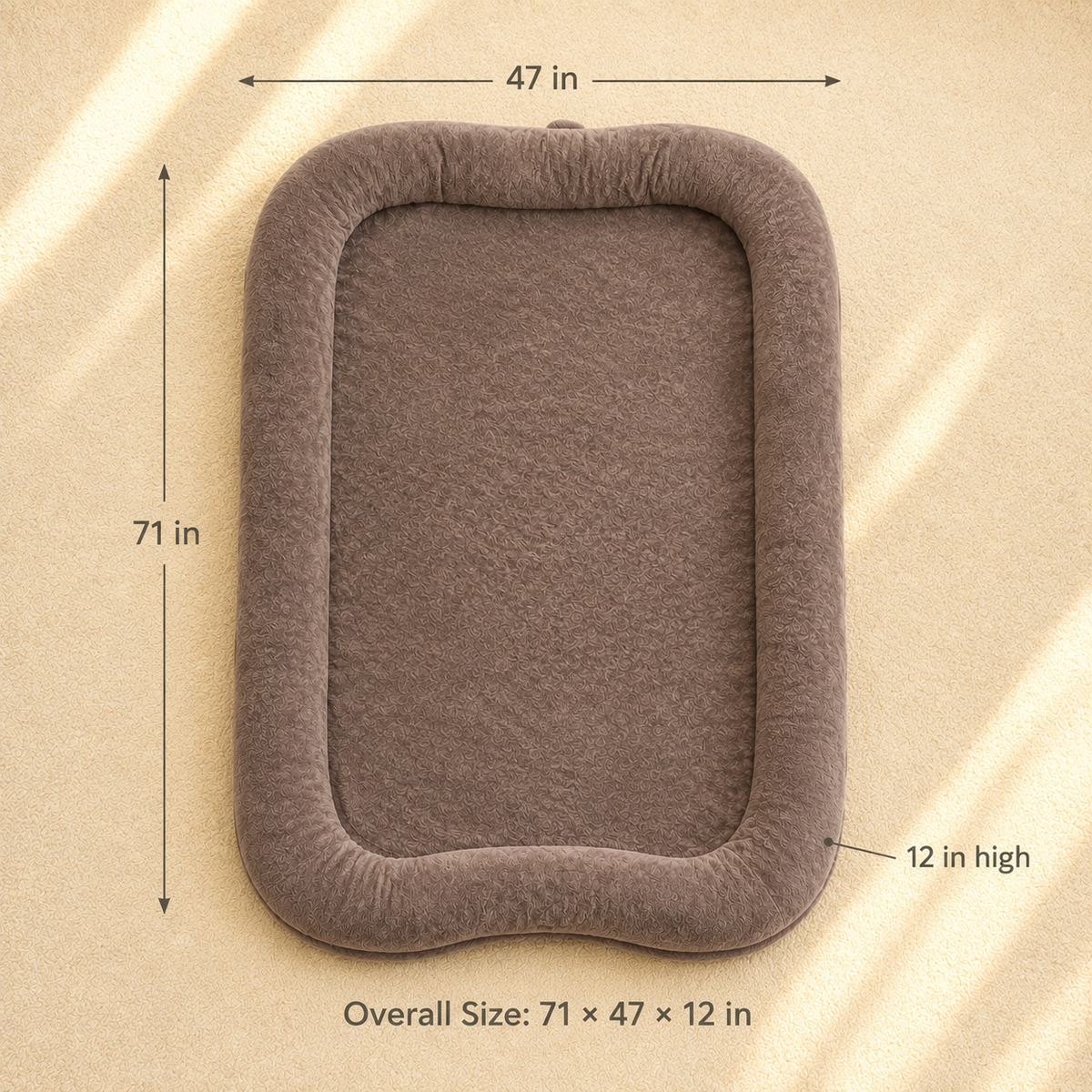 A rectangular plush pet bed or cushion in taupe-brown with dimension callouts showing 71 in by 47 in overall size and 12 in high, on a beige textured background.