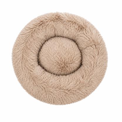 A round, plush faux-fur pet bed in a light beige color, photographed from directly above on a solid white background.