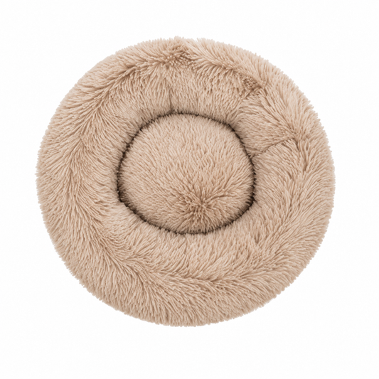 A round, plush faux-fur pet bed in a light beige color, photographed from directly above on a solid white background.