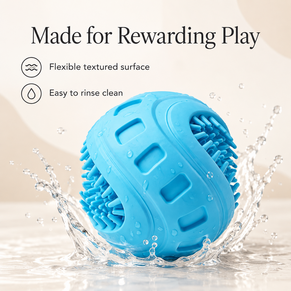 A bright blue interactive chew dog toy ball with a textured, flexible surface, shown in a splash of water with promotional text reading 'Made for Rewarding Play' and feature icons for 'Flexible textured surface' and 'Easy to rinse clean