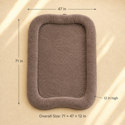 A rectangular plush pet bed or cushion in taupe-brown with dimension callouts showing 71 in by 47 in overall size and 12 in high, on a beige textured background.